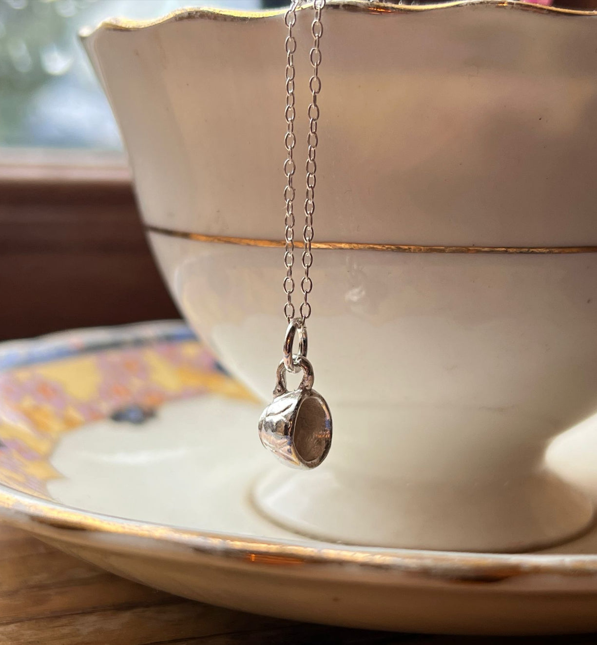Tiny silver teacup necklace with on a saucer with a teacup, mindful gift thich Nhat Hanh