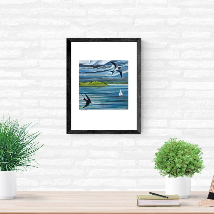 Framed A4 art print , Swallows and sails, coastal art in room setting on brick wall