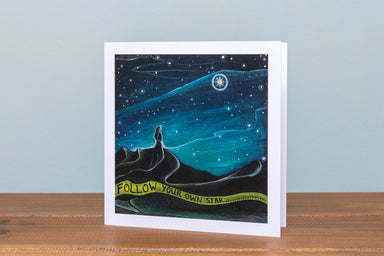 Figure against night sky looking a the bright star of guidance and encouragement to follow your own path, graduation card, new chapter , time of change, mindful art